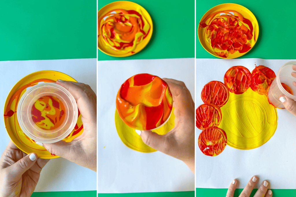 3 Photos: (1) a clear plastic cup is pushed into the center of a plate where red, orange, and yellow paint are mixed, (2) the cup is lifted and the bottom shows the paint swirled together, (3) the painted cup bottom is stamped onto a paper on the edge of a yellow painted circle as a flower petal. 