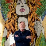 Chuck Sperry Stands In Front Of Full Scale Print Of Woman